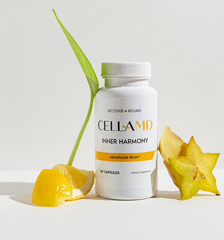 A bottle of CellAMD Inner Harmony menopause relief dietary supplement sits on a white surface with lemon slices and star fruit. 60 capsules. RECOVER ● REGAIN.