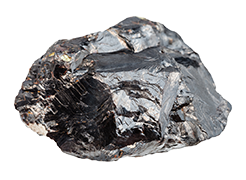 A dark gray, metallic-looking mineral rests on a plain white background. Its rough, crystalline structure is prominently displayed.